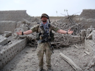 Ben in front of blown up building. (2)